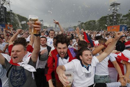 England fans hold glasses of beer while reacting after their team scores goal as they watch the England v Wales EURO 2016 Group B soccer match.
