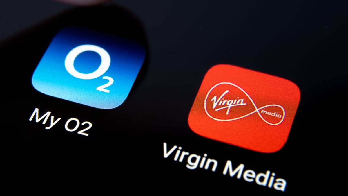 Virgin Media and My O2 apps on smartphone screen and finger pressing one of them