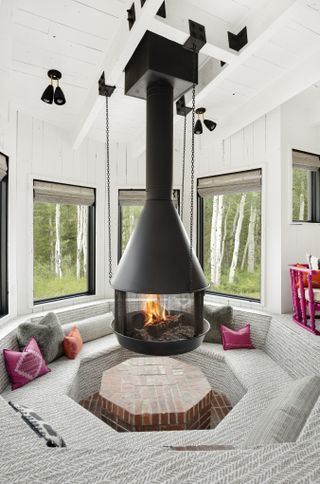 A fireplace suspended in the middle of seating