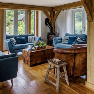 living room with blue sofa with cast iron fireplace