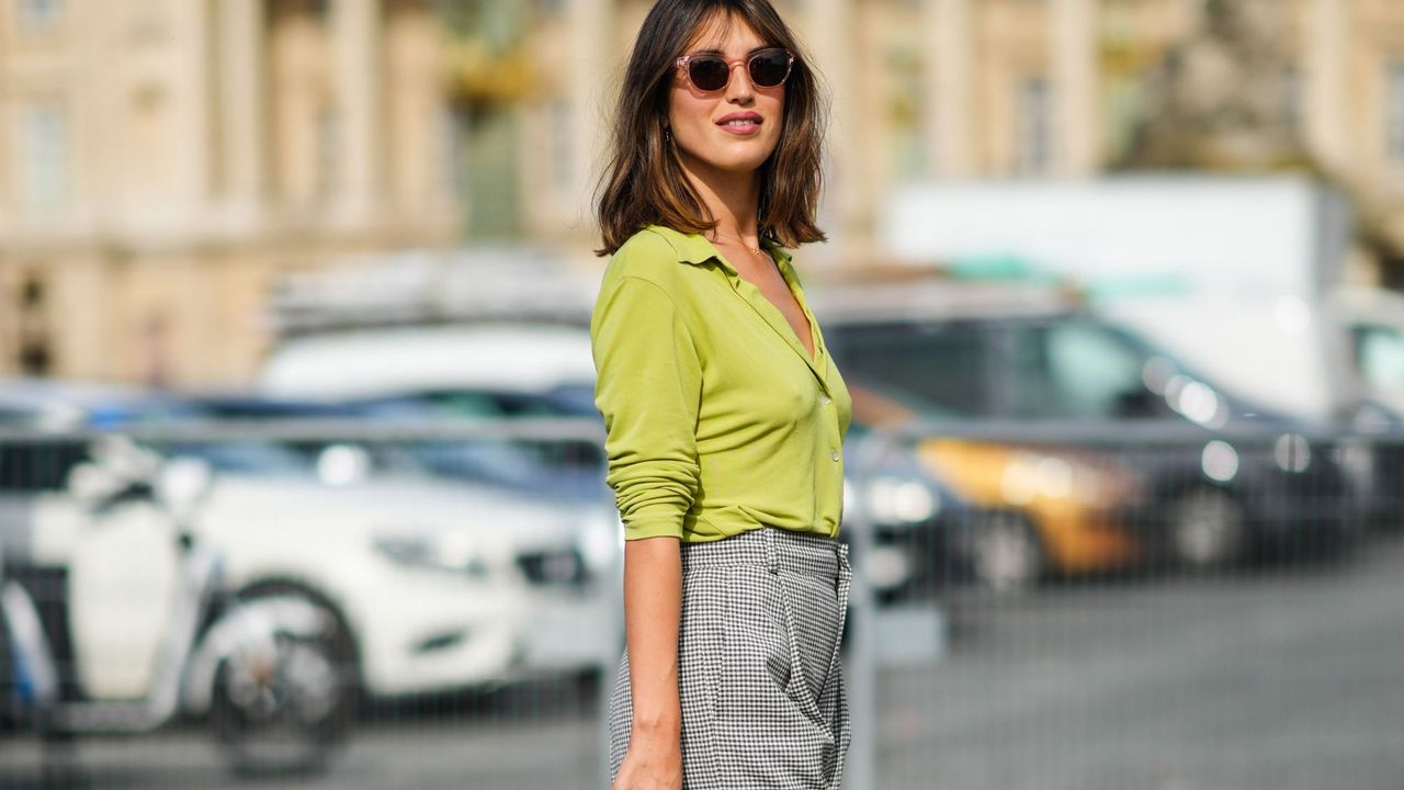 Jeanne Damas spotted at Paris Fashion Week wearing a green cardigan and trousers