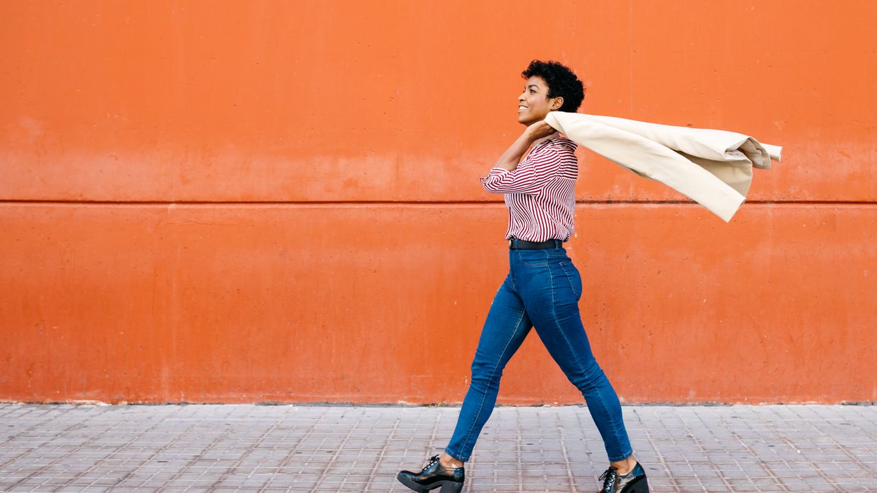 Woman walking mindfully through a city