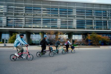 Four riders on Brompton bikes