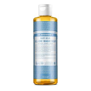 A clear bottle of Dr. Bronner's castile soap with white lid and blue and white label