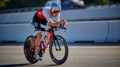 best triathlon bike: pictured here, a person riding a tri bike wearing a full cycling gear