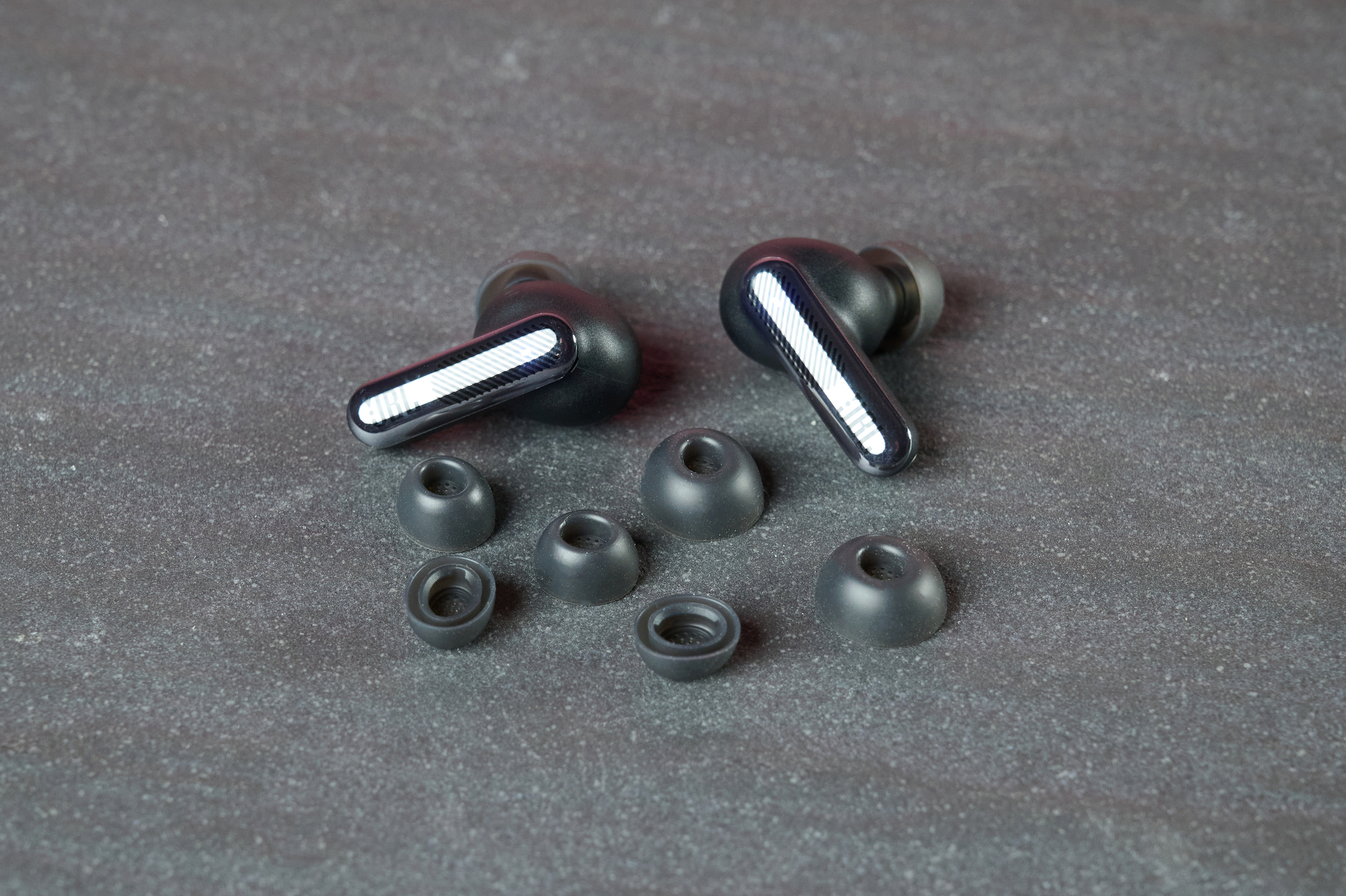 JBL Live Beam 4 on table with various eartips