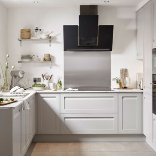 light grey kitchen with stainless steel kitchen splashback