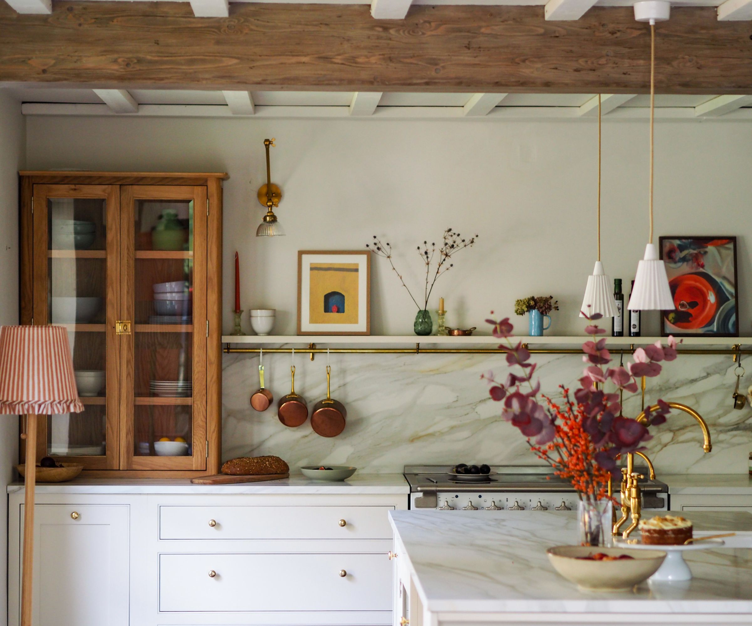 A country kitchen with white and wood cabinets