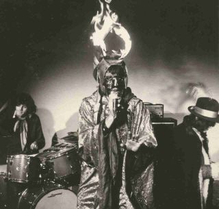 Arthur Brown performing onstage while wearing a flaming helmet in 1968