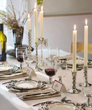 Black and white Thanksgiving table with decorative plates and pops of red