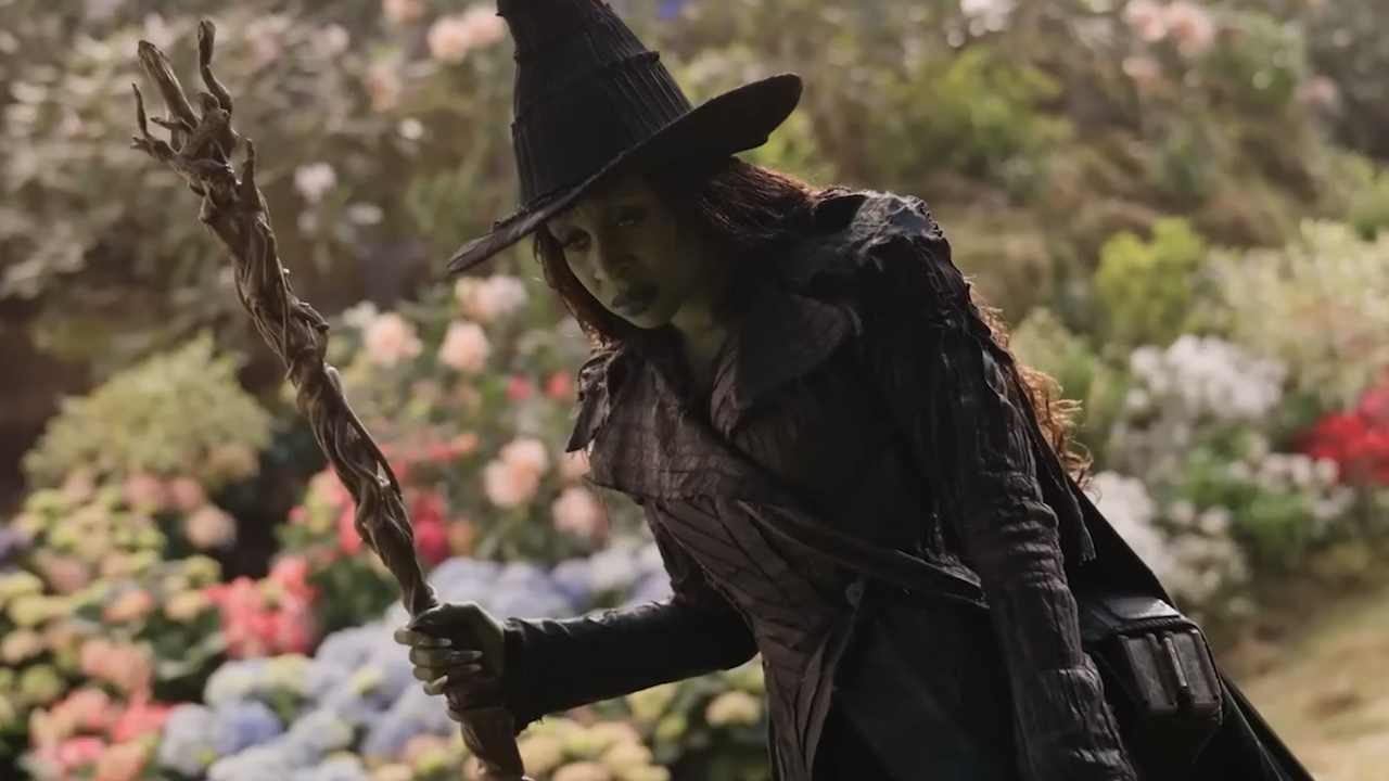 Elphaba standing with her broom on the yellow brick road in Wicked: For Good