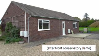 A red brick bungalow with gravelled front drive