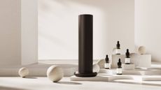 Photo of Aromatech diffuser and fragrances on white background