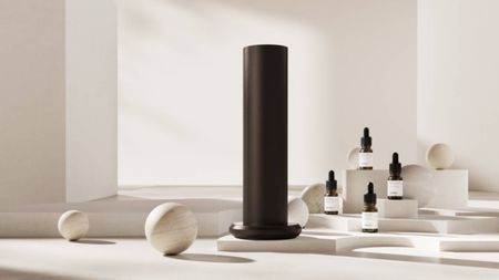 Photo of Aromatech diffuser and fragrances on white background