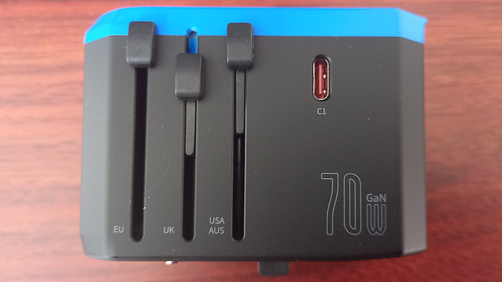 Side of Ceptics 70W World Travel Plug Adapter on desk showing USB ports