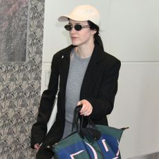 Rachel Brosnahan carries a Longchamp bag.
