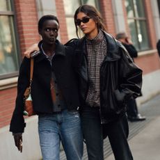 Model wears a leather bomber jacket at Milan Fashion Week
