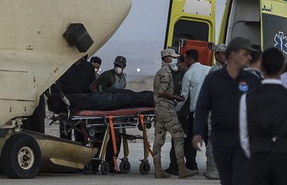 Paramedics load bodies of Russian plane crash victims into military aircraft