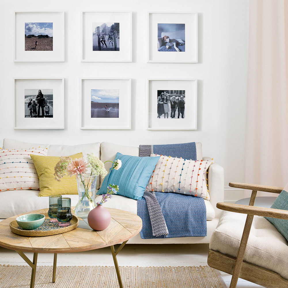 living room with wooden flooring with sofa with cushions