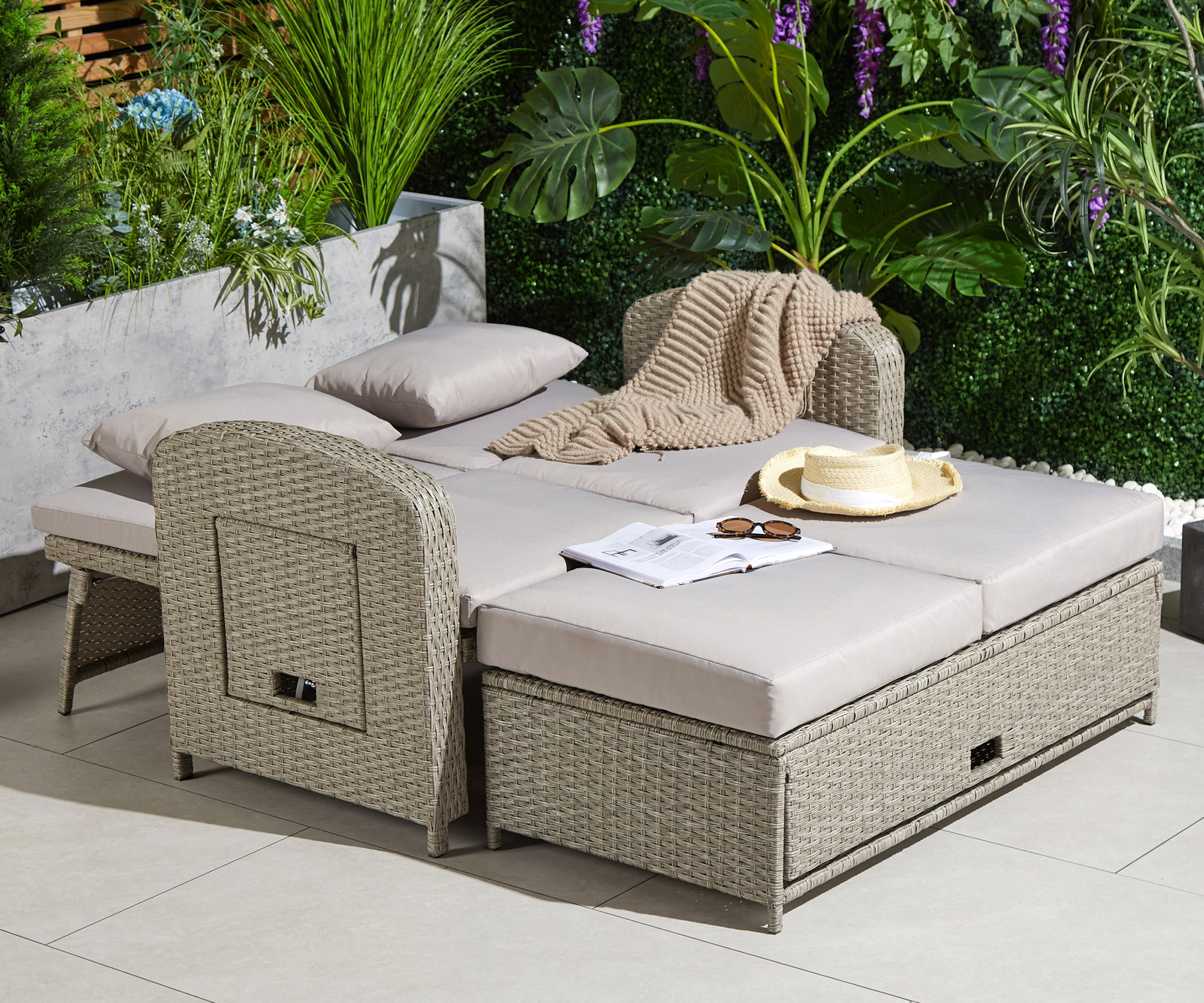 multi-purpose garden furniture set in small patio space with planting