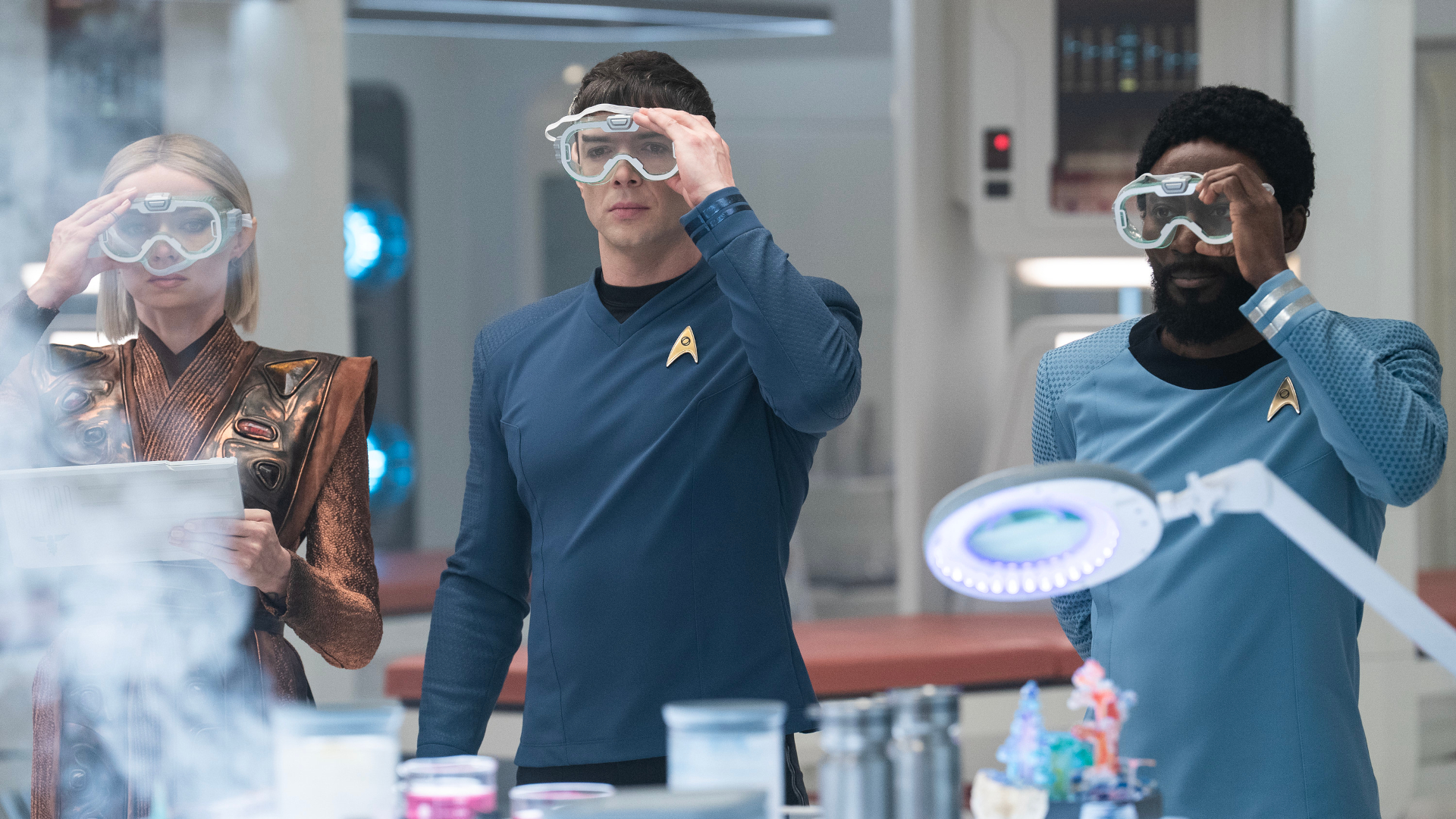 L to R Jess Bush as Chapel, Ethan Peck as Spock and Babs Olusanmokun as Dr. M&amp;Atilde;&amp;shy;Benga in season 3 , Episode 8 of Strange New Worlds streaming on Paramount+. Photo Credit: Marni GrossmanParamount+