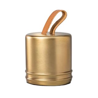 A gold doorstop with a brown leather loop on top of it