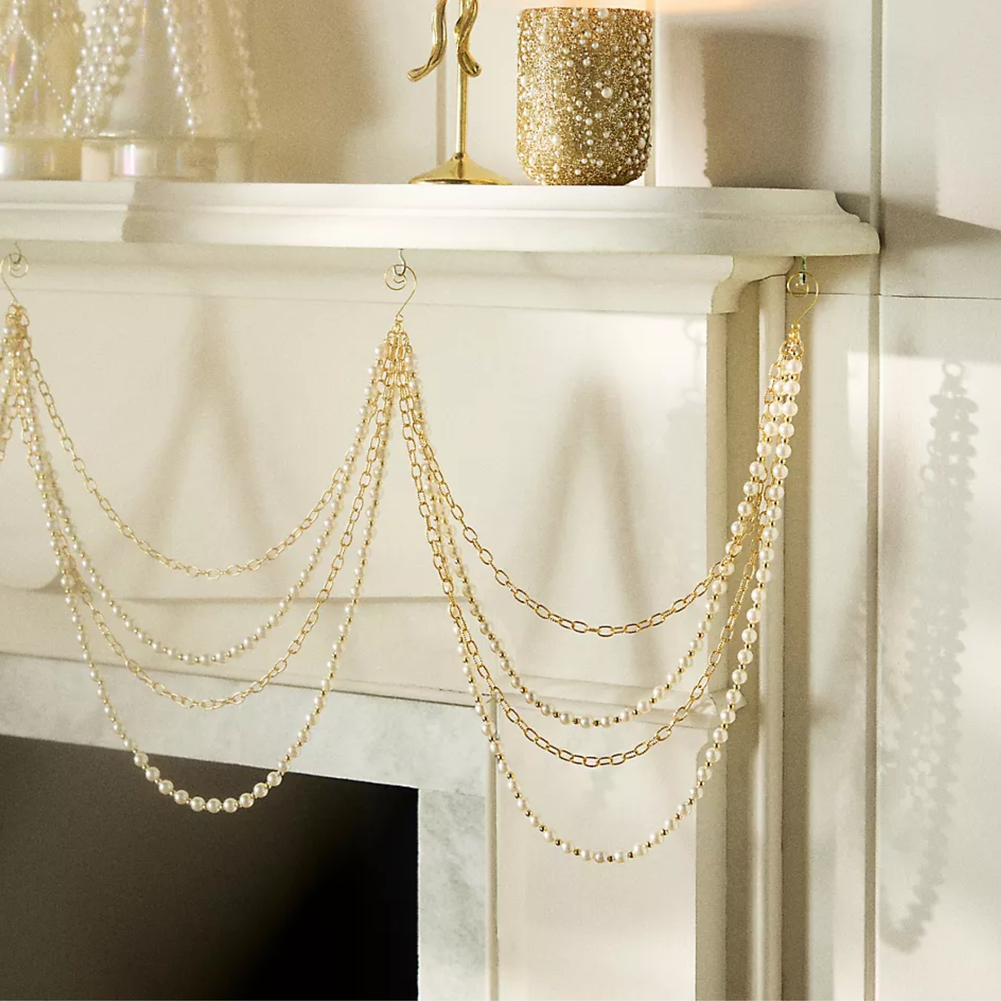 a strand of pearl garland hanging from a mantel