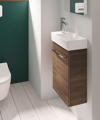 Minimalist small bathroom with clean lines, a floating wooden vanity, and a crisp white rectangular sink.