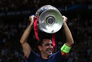 Xavi celebrates with the Champions League trophy after Barcelona's win over Juventus in the 2015 final in Berlin.