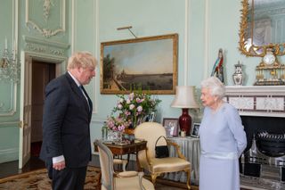 Britain's Queen Elizabeth II greets Britain's Prime Minister Boris Johnson during an audience at Buckingham Palace in central London on June 23, 2021, the Queen's first in-person weekly audience with the Prime Minister since the start of the coronavirus pandemic. (Photo by Dominic Lipinski / POOL / AFP) (Photo by DOMINIC LIPINSKI/POOL/AFP via Getty Images)