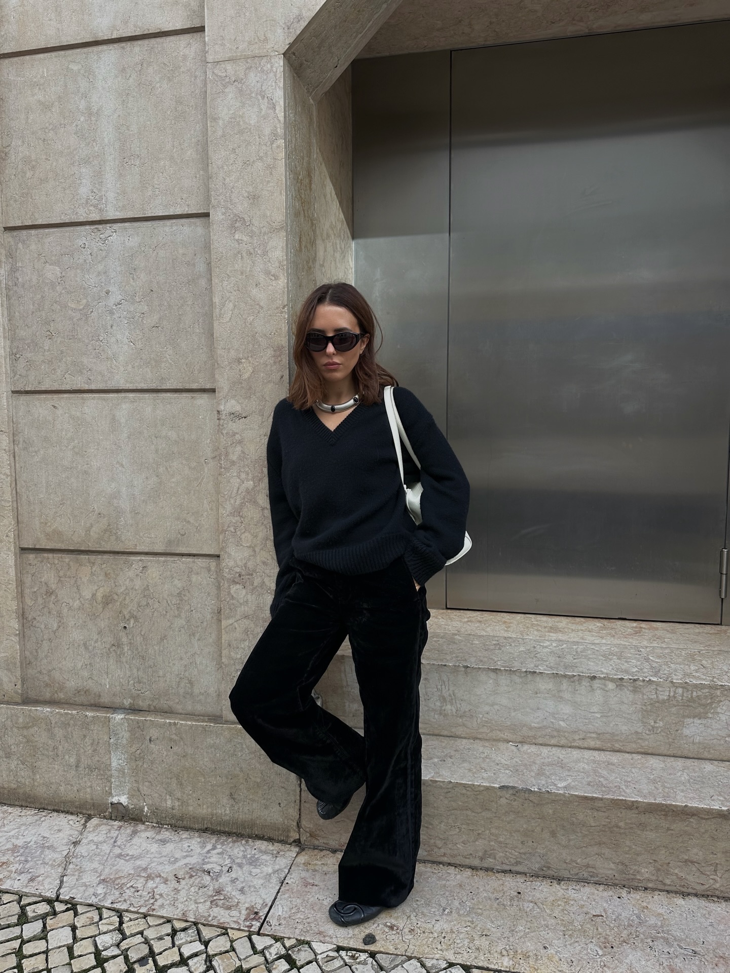 An image of @deborabrosa wearing a V-neck top, one of the best long-sleeved tops for women.