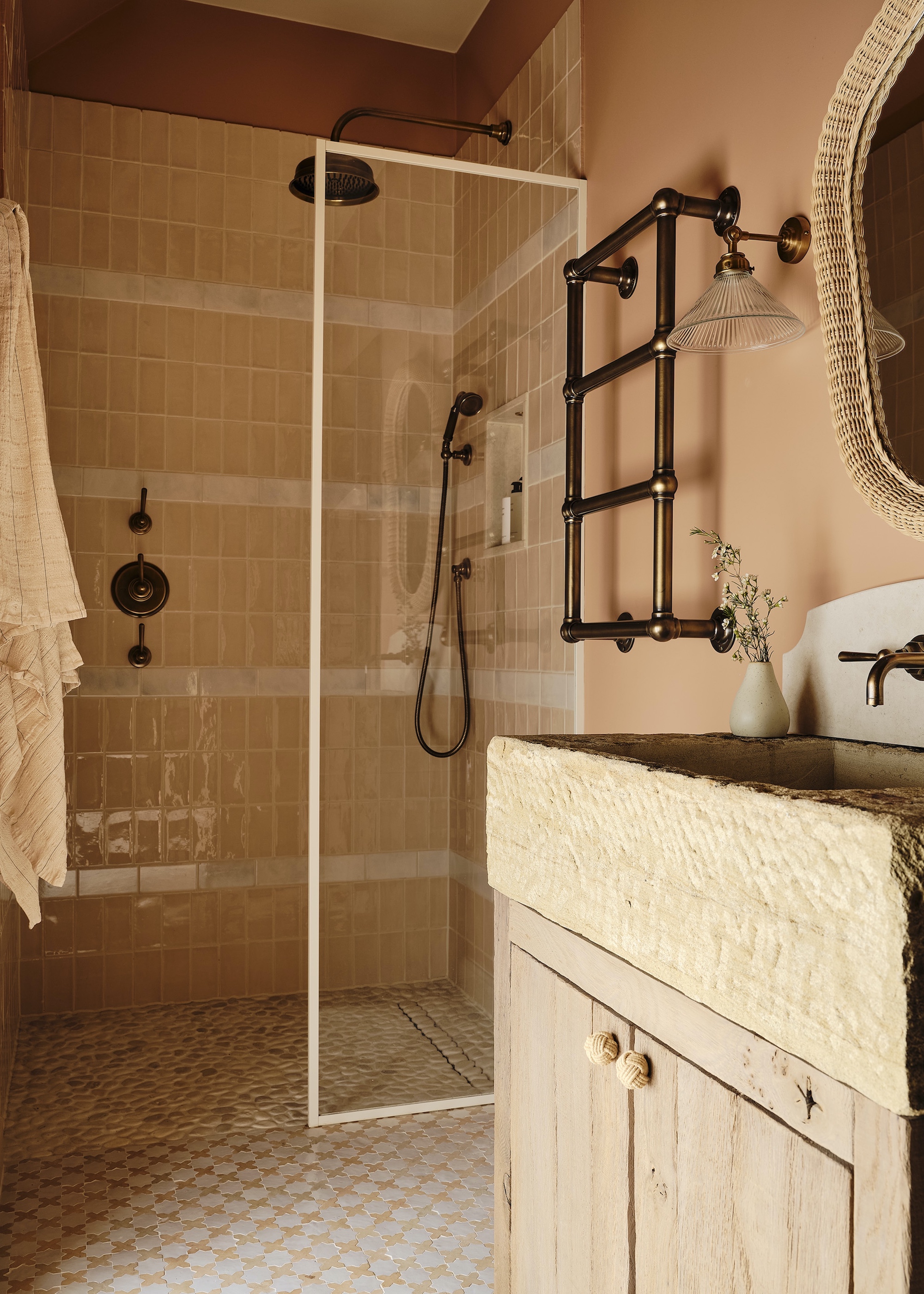 bathroom with zellige tiles and rugged basin. There is also a section for the shower and a kitchen sink with cabinets at the bottom
