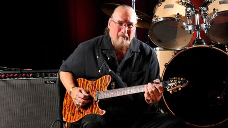 Steve Cropper poses with his Peavey signature guitar and a Fender Twin combo