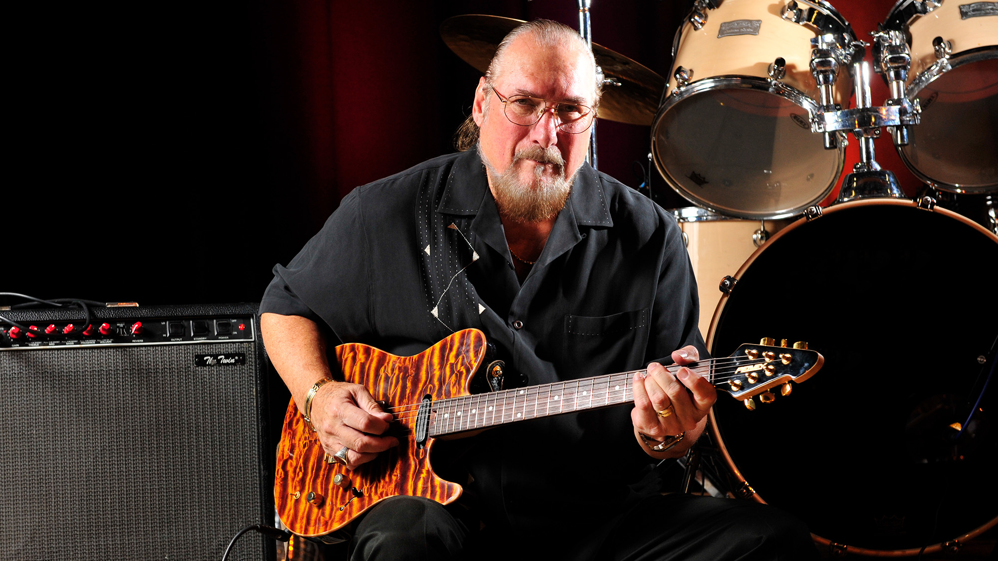 Steve Cropper poses with his Peavey signature guitar and a Fender Twin combo