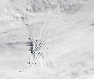 Clouds slice open as they cross the high peaks of the South Sandwich Islands.