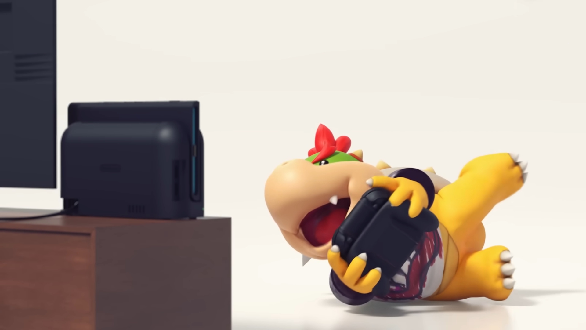 Baby Bowser rolls on the floor playing a Switch 2