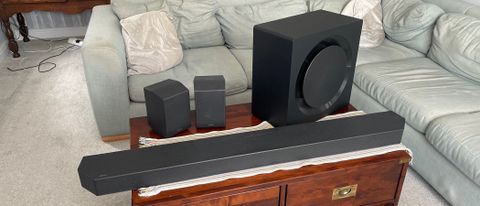 The Samsung HW-Q990C soundbar system pictured on a wooden table.