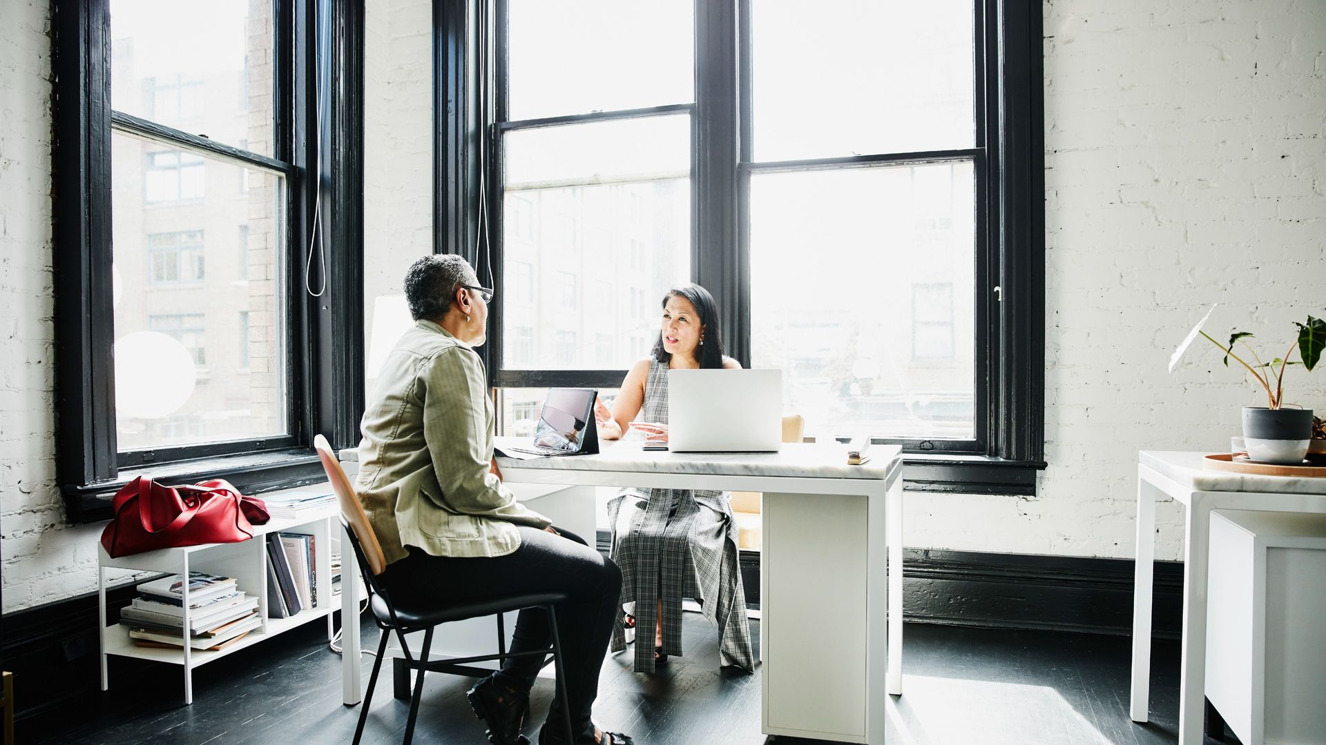 women in an office discussing business