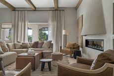 a neutral living room with lots of textured seating