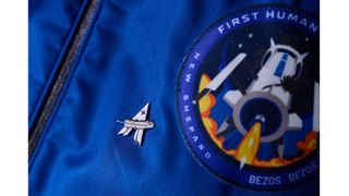 The Blue Origin "astronaut pin" that all crew members receive after flight, next to the patch for the first New Shepard mission.