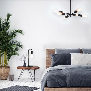 bedroom with white wall and black table lamp and ceiling light