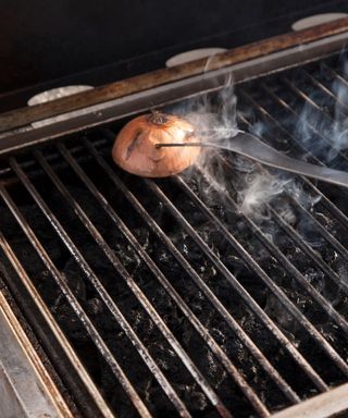 Cleaning a grill with half an onion