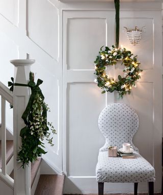 Christmas wreath in hallway by stairs