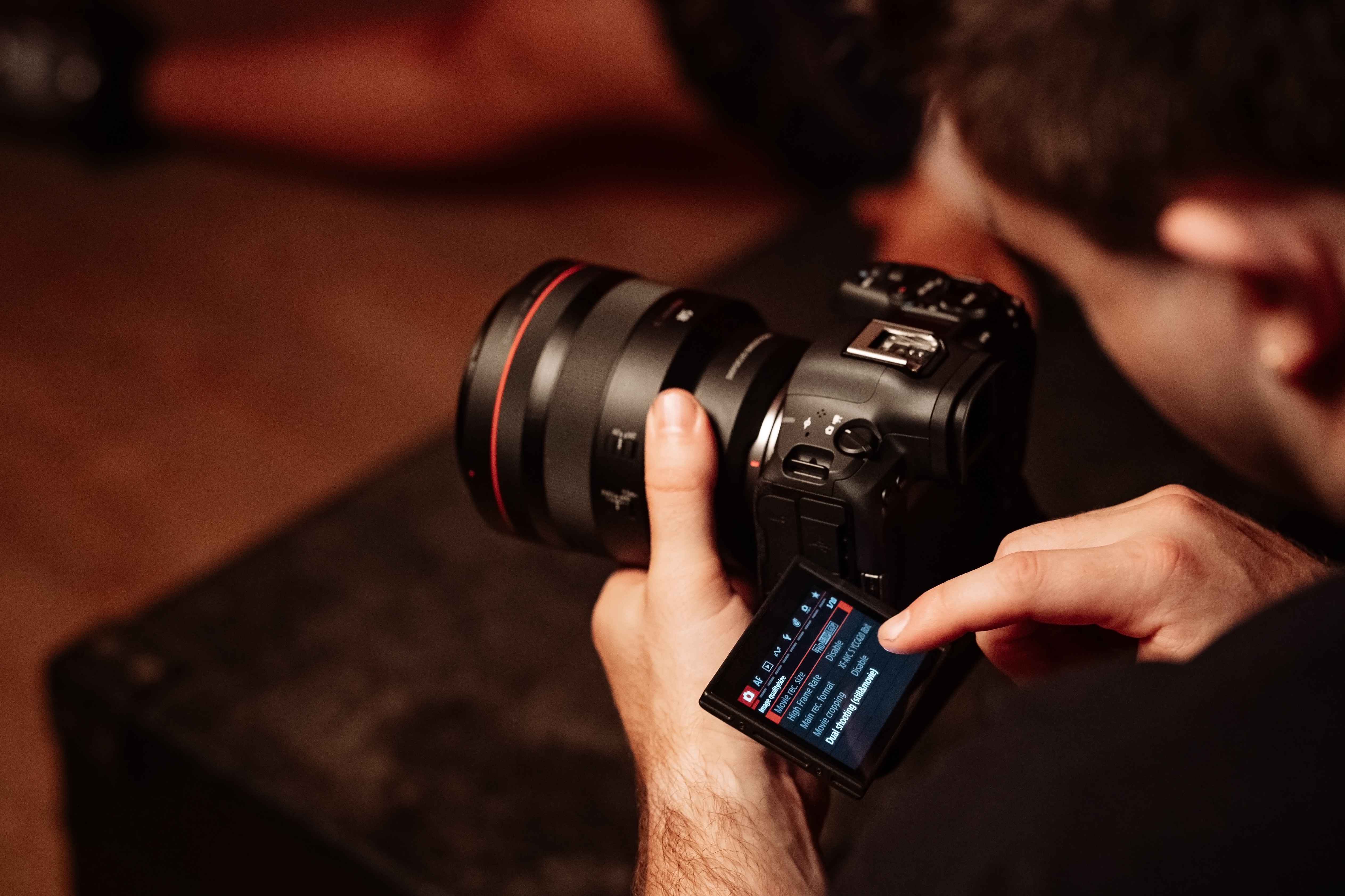 Two hands holding the Canon EOS R5 Mark II