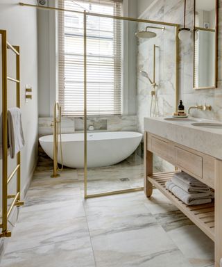 Marble bathroom with brass fixtures and fitting,modern tub, vanity,