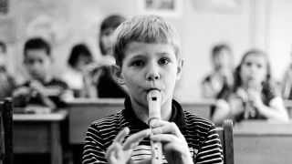 A child playing a recorder