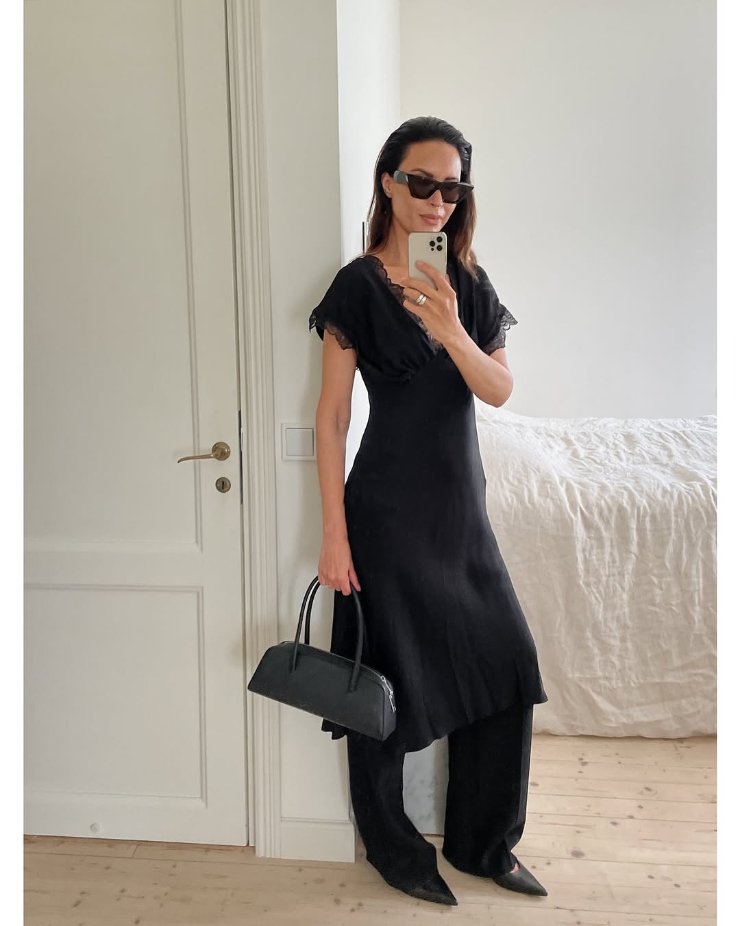 woman wearing dress over pants fall outfit 2025