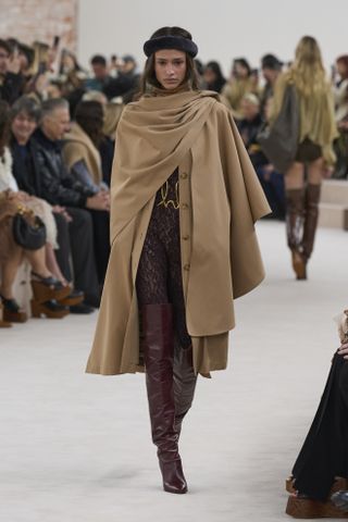 Woman in wrap coat on Chloé runway