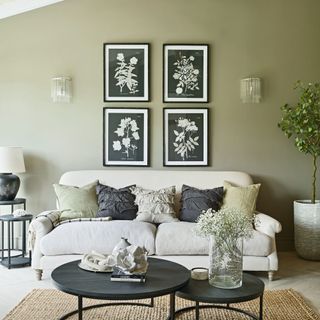 living room with black coffee tables, cream sofa and cushions, and gallery wall art