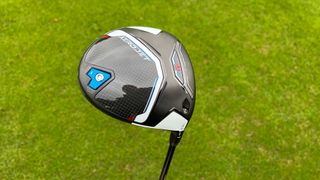 Cobra Aerojet Driver showing off its glossy clubhead and blue and red detailing on the golf course